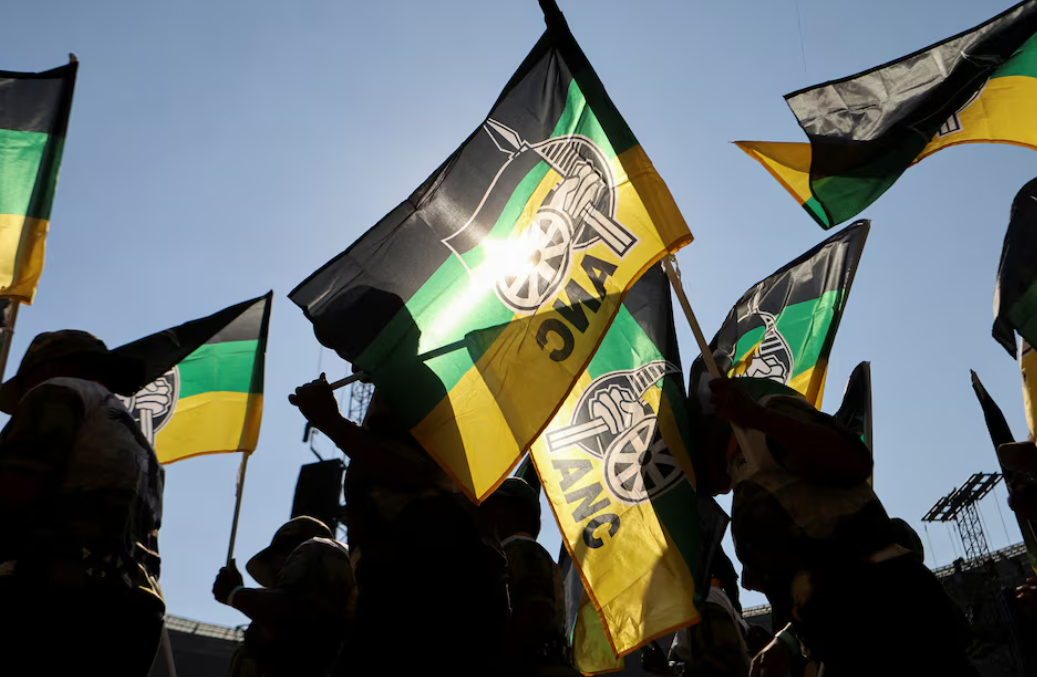 Supporters of the African National Congress (ANC) wave party flags. Reuters