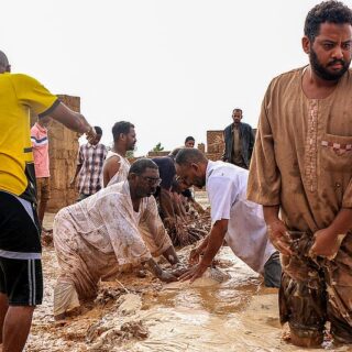 Men create a make-shift embankment out of mudbrick amidst flooding in Masawi near Meroe in Sudan's Northern State on August 27, 2024.FILE.